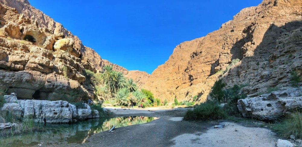 From Muscat: Wadi Shab & Bimah Sinkhole Adventure | ®ExcursionMania
