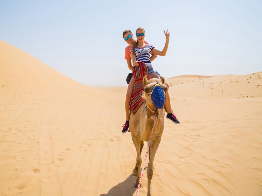 Abu Dhabi: Desert Safari with BBQ Camel Ride & Sandboarding | ®ExcursionMania
