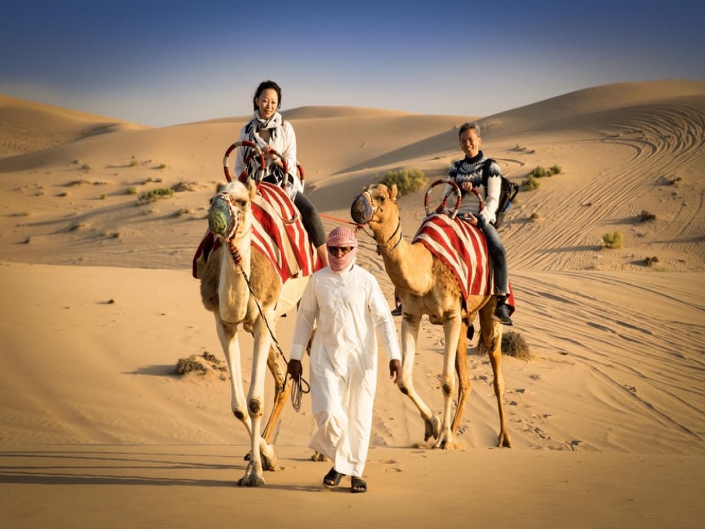 Abu Dhabi: Desert Safari with BBQ Camel Ride & Sandboarding | ®ExcursionMania
